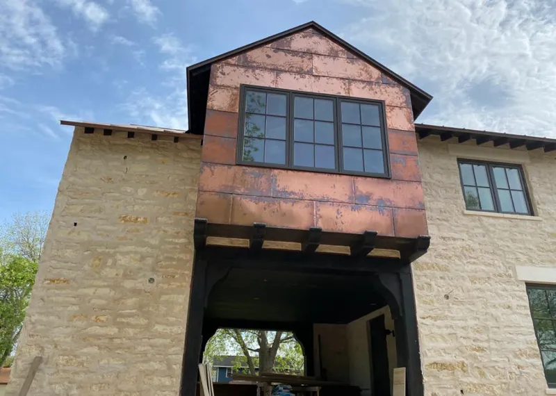 Copper metal panel facade on a stone building for Skylight Installation in Harwinton